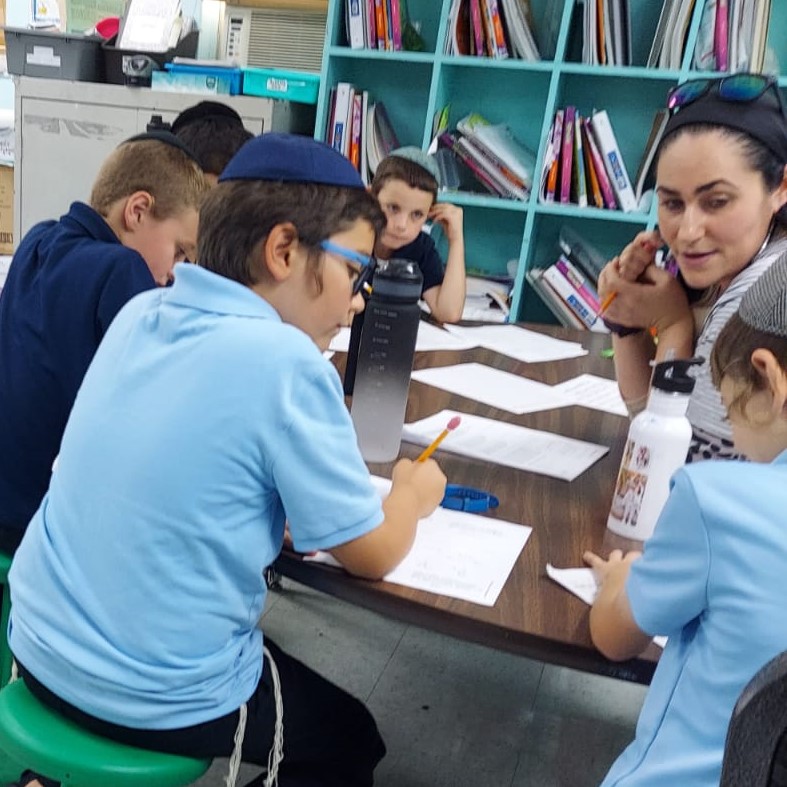 Students and teacher learn in a small group