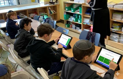 A classroom of students learning with a teacher