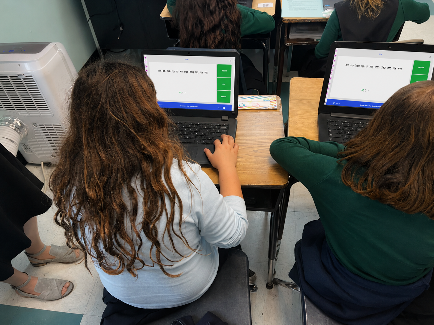 Students using MasterED on laptops